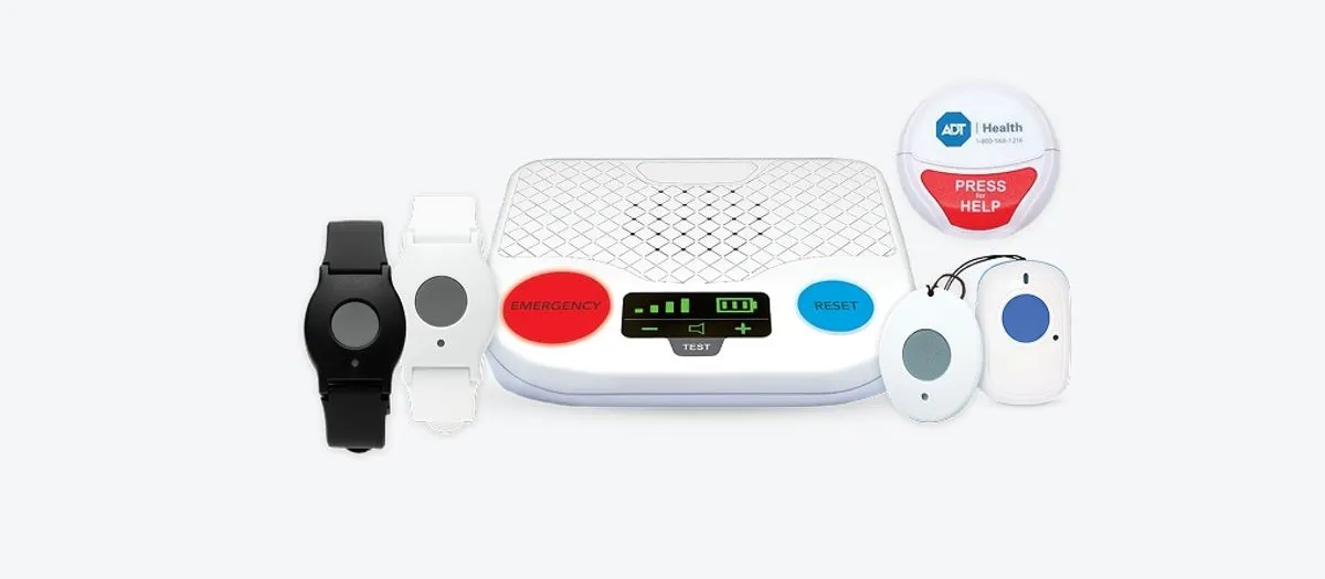 ADT Health medical alert equipment: in-home base station with emergency and reset buttons, wrist help buttons, pendant buttons, and an ADT Health wall-mount help button